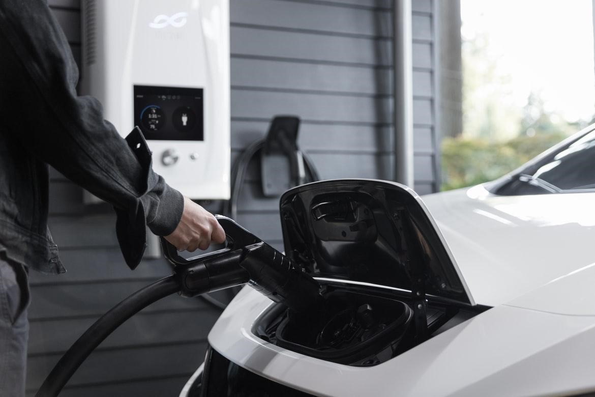 An electric car being plugged into a hybrid inverter