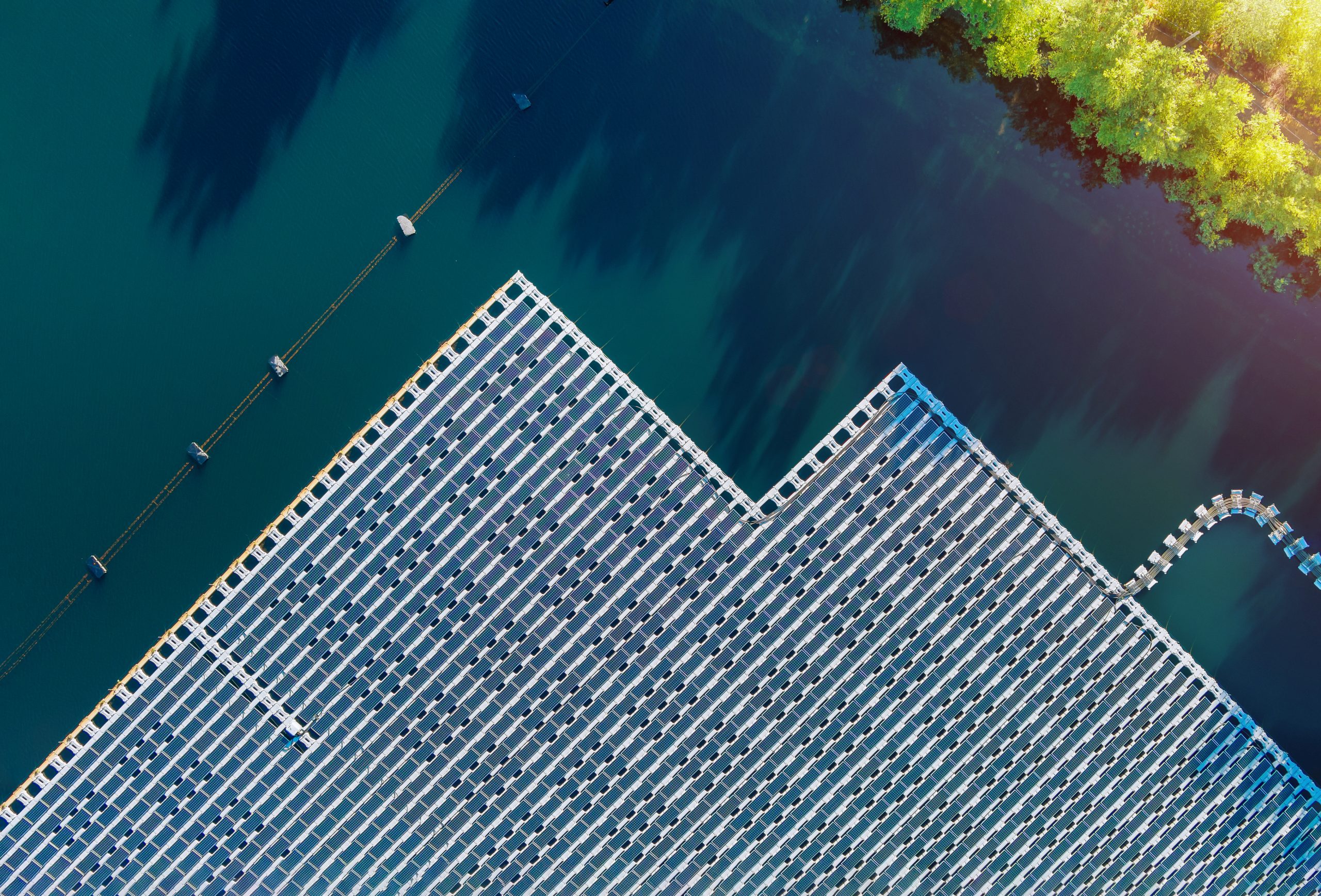 Floating solar panels platform on the beautiful lake renewable alternative electricity energy of panorama aerial view